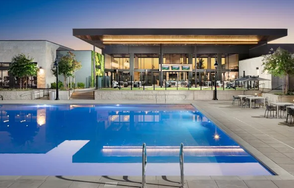 Regency clubhouse and swimming pool at dusk